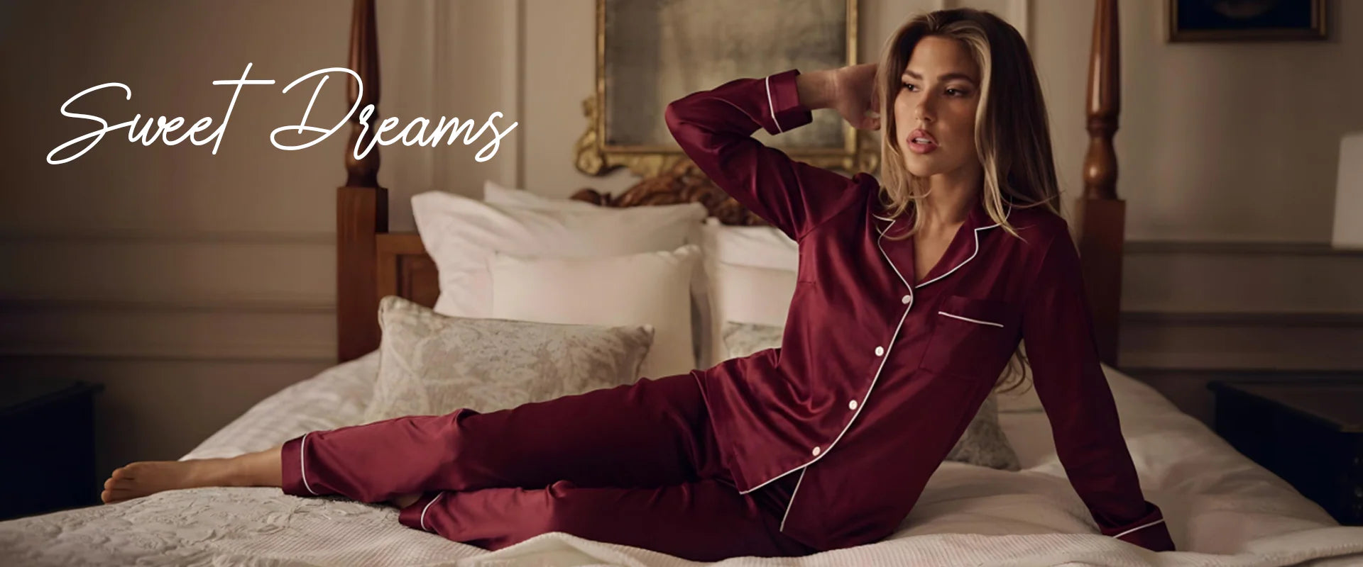 Woman in burgundy pajamas sitting on a bed with 'Sweet Dreams' text.